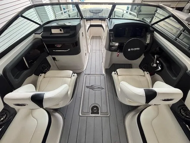 Slide: The Image of 2023 Chaparral 267 SSX boat interior with sleek seating and modern dashboard. - 6
