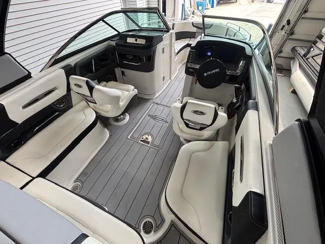 Slide: The Image of 2023 Chaparral 267 SSX boat interior with sleek seating and modern dashboard design. - 9