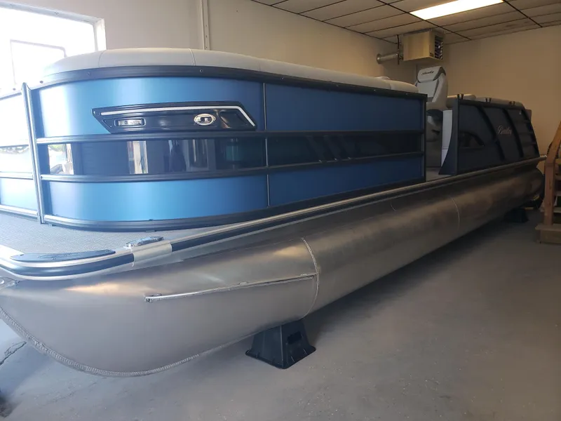 The Image of 2025 Bentley Pontoons Elite Admiral in showroom, featuring sleek blue design and modern amenities. - 0