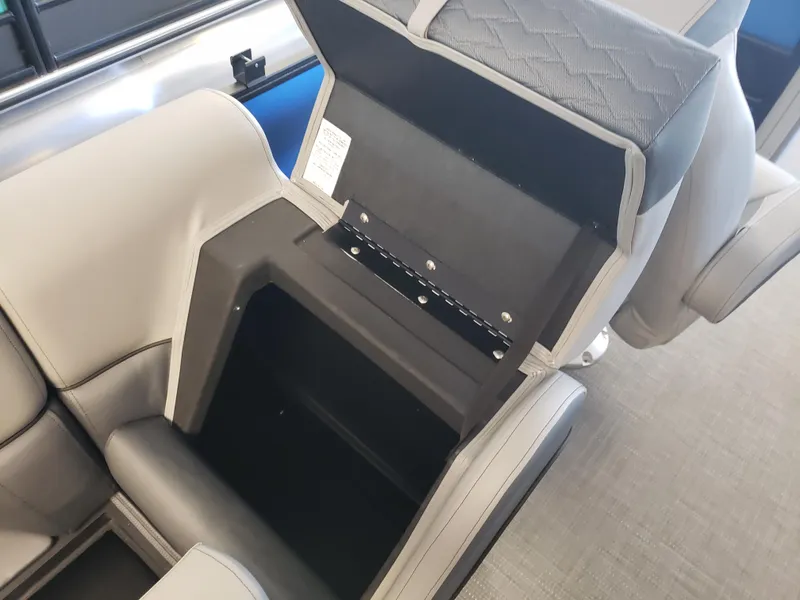Slide: The Image of 2025 Bentley Pontoons Elite Admiral seat storage compartment, open with visible interior space. - 11