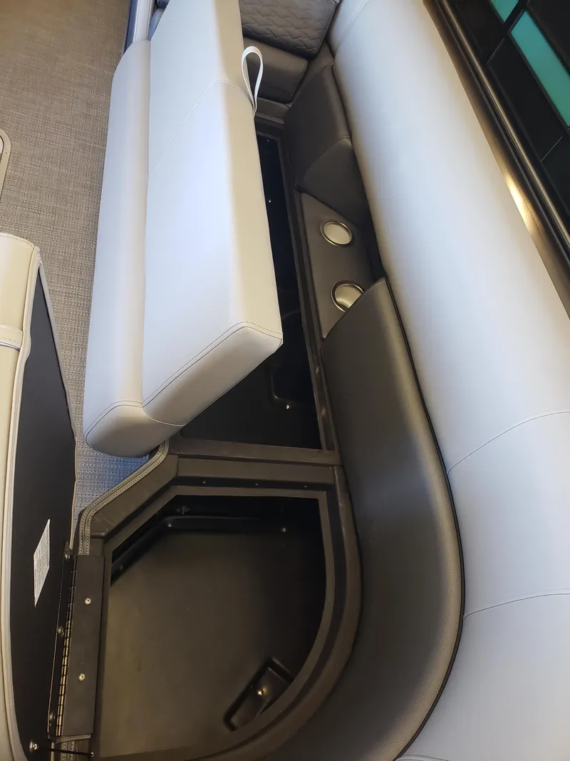 Slide: The Image of 2025 Bentley Pontoons Elite Admiral interior seating with storage compartment open. - 15
