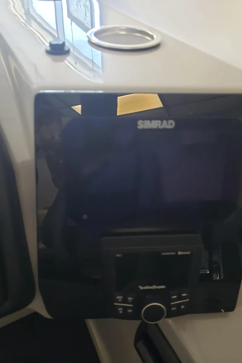 Slide: The Image of 2025 Bentley Pontoons Elite Admiral dashboard with Simrad navigation system. - 19