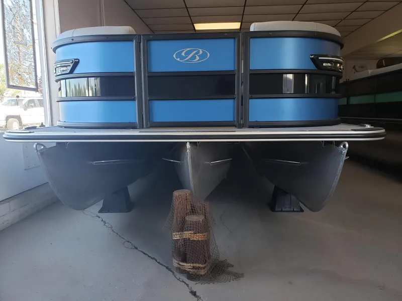 Slide: The Image of 2025 Bentley Pontoons Elite Admiral, blue pontoon boat, displayed indoors. - 2