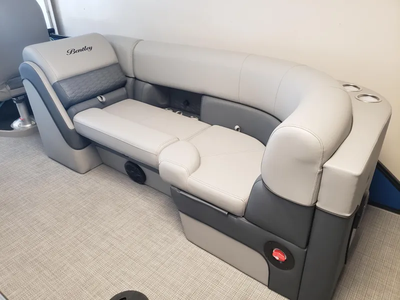 Slide: The Image of 2025 Bentley Pontoons Elite Admiral boat seating, featuring luxurious gray upholstery and cup holders. - 7