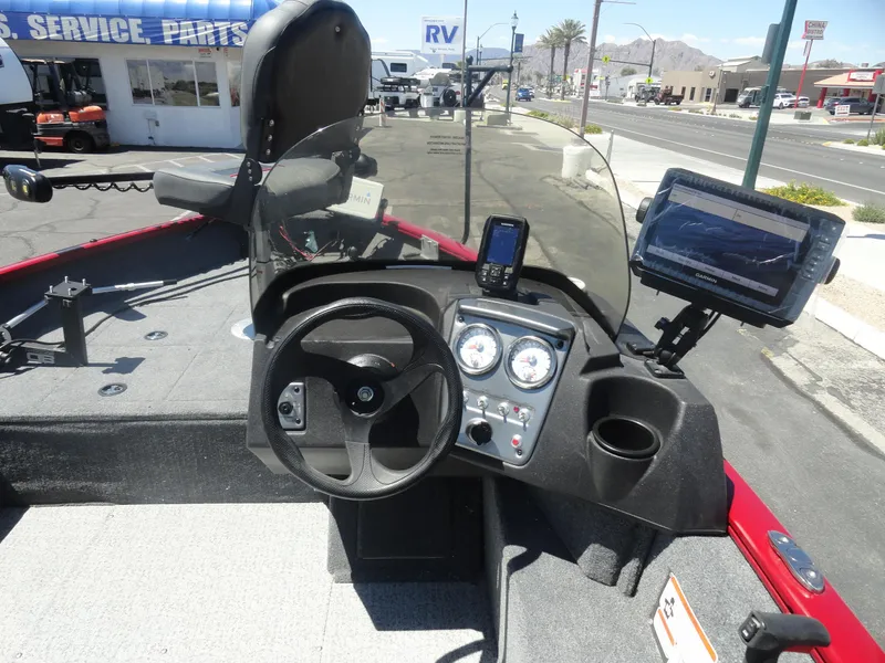 Slide: The Image of 2024 Tracker Pro Guide V-16 SC boat dashboard with steering wheel and navigation equipment. - 10