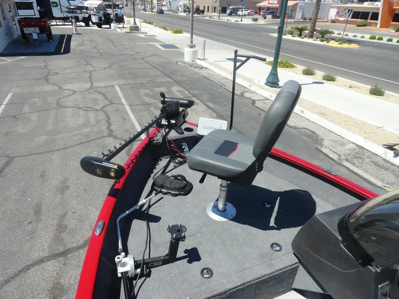 Slide: The Image of 2024 Tracker Pro Guide V-16 SC boat with fishing seat and trolling motor in a parking lot. - 13