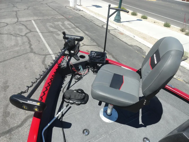 Slide: The Image of 2024 Tracker Pro Guide V-16 SC boat interior with seating and control panel. - 14