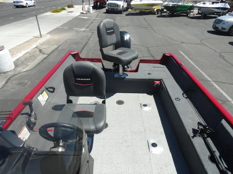 Slide: The Image of 2024 Tracker Pro Guide V-16 SC boat interior with seating and steering wheel. - 17