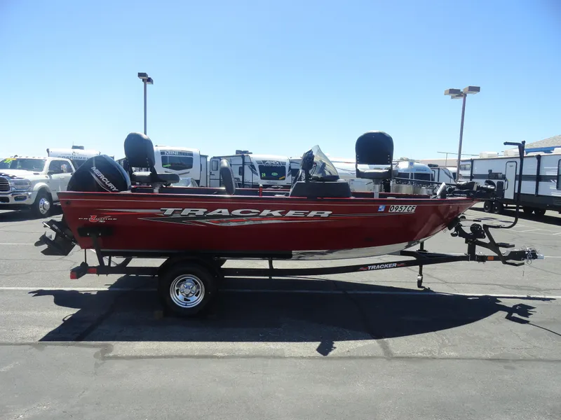 Slide: The Image of 2024 Tracker Pro Guide V-16 SC boat in a parking lot, side view. - 7