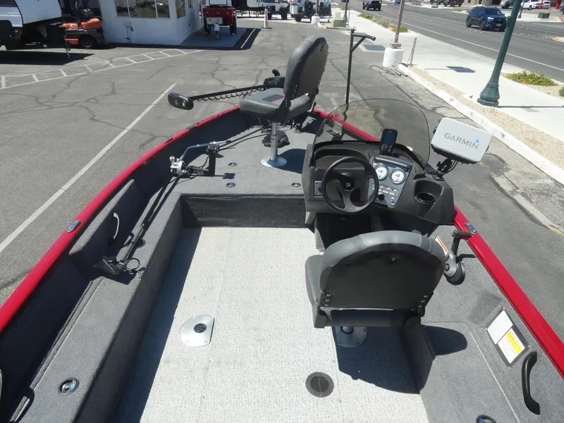 Slide: The Image of 2024 Tracker Pro Guide V-16 SC boat interior with steering console and Garmin device. - 8