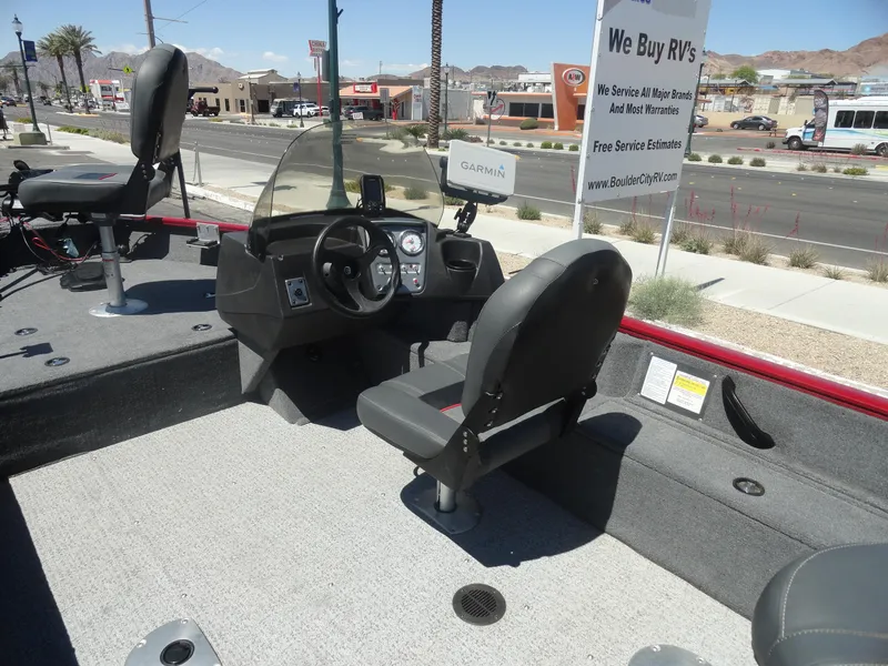 Slide: The Image of 2024 Tracker Pro Guide V-16 SC boat interior with steering console and seating. - 9