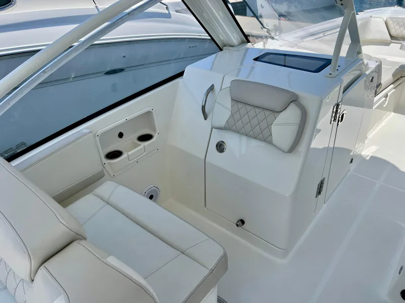 Slide: The Image of 2024 World Cat 280DC-x boat interior with white seating and storage compartments. - 12