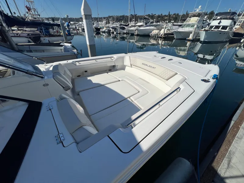 Slide: The Image of 2024 World Cat 280DC-x boat docked in marina, featuring spacious seating area. - 15