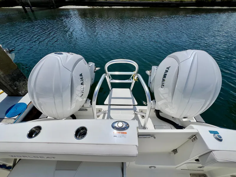 Slide: The Image of 2024 World Cat 280DC-x boat with dual Yamaha outboard engines on a calm waterway. - 24
