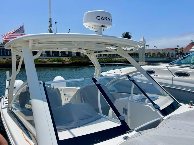 Slide: The Image of 2024 World Cat 280DC-x boat with Garmin radar, docked in a marina. - 25