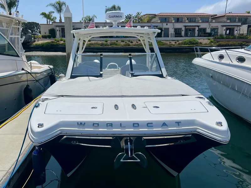 Slide: The Image of 2024 World Cat 280DC-x boat docked in a marina, showcasing sleek design and modern features. - 5