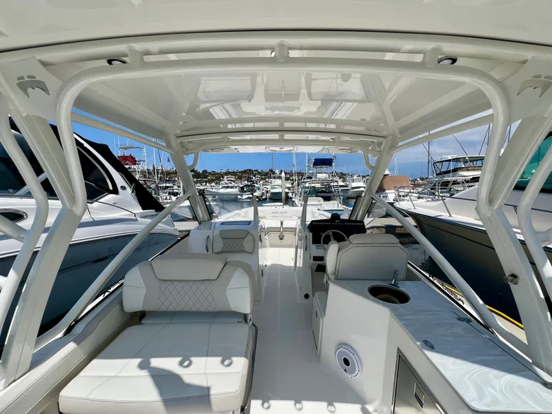 Slide: The Image of 2024 World Cat 280DC-x boat interior with seating, docked at marina. - 8