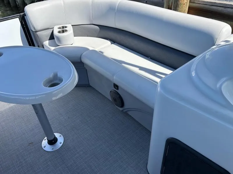 Slide: The Image of 2020 Bentley Pontoons LE 180 Cruise interior with gray seating and table. - 10