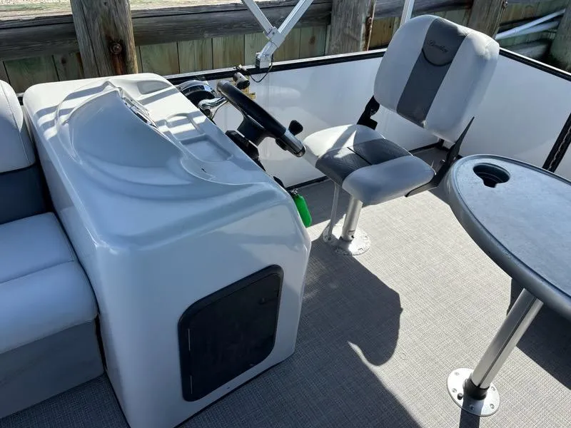Slide: The Image of 2020 Bentley Pontoons LE 180 Cruise interior with helm, seat, and table. - 11