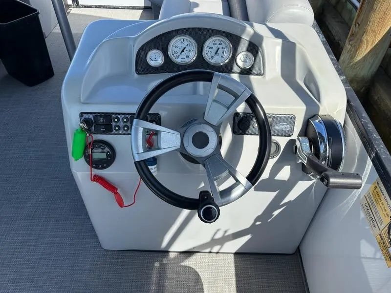 Slide: The Image of 2020 Bentley Pontoons LE 180 Cruise steering console with gauges and controls. - 12