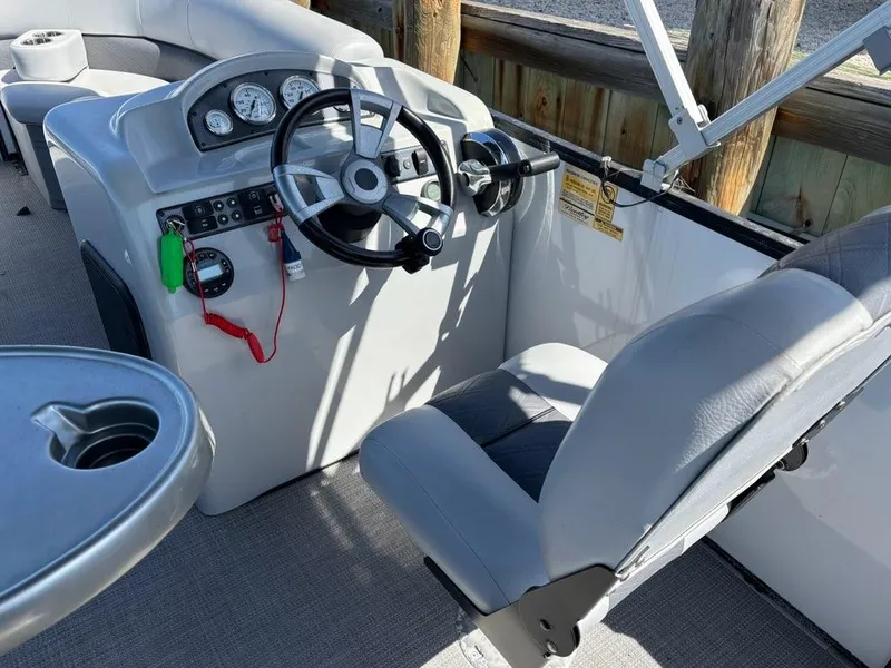 Slide: The Image of 2020 Bentley Pontoons LE 180 Cruise helm with steering wheel and controls. - 13