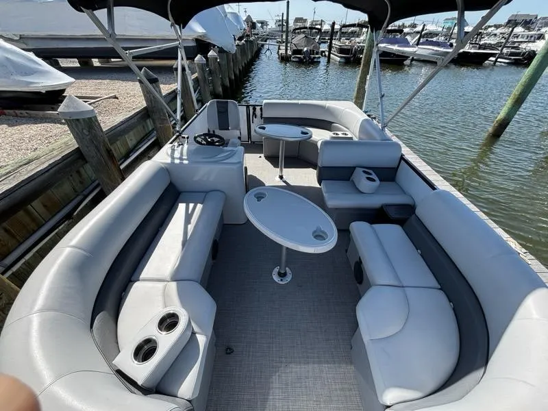 Slide: The Image of 2020 Bentley Pontoons LE 180 Cruise with spacious seating and table, docked at marina. - 5