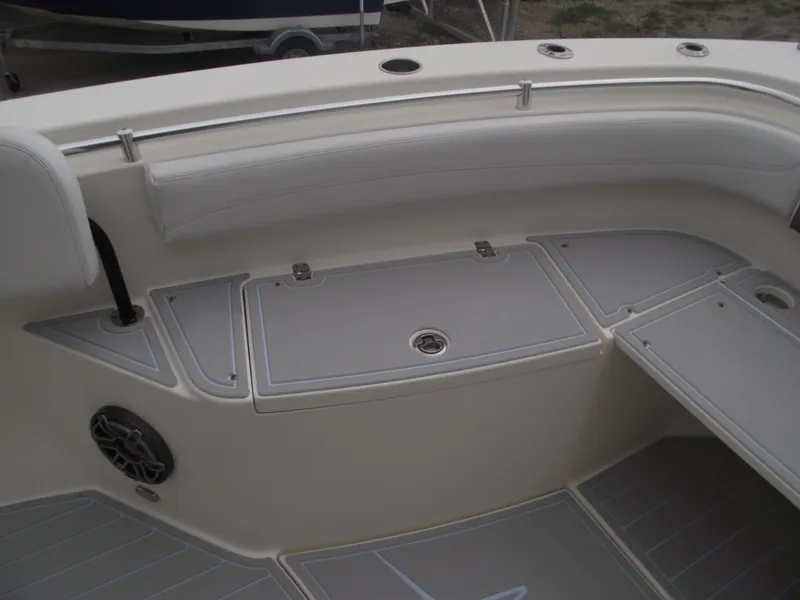 Slide: The Image of 2021 Cobia 301 Center Console boat interior with seating and storage compartments. - 10