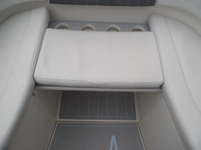 Slide: The Image of 2021 Cobia 301 Center Console boat interior with cushioned seating and cup holders. - 12