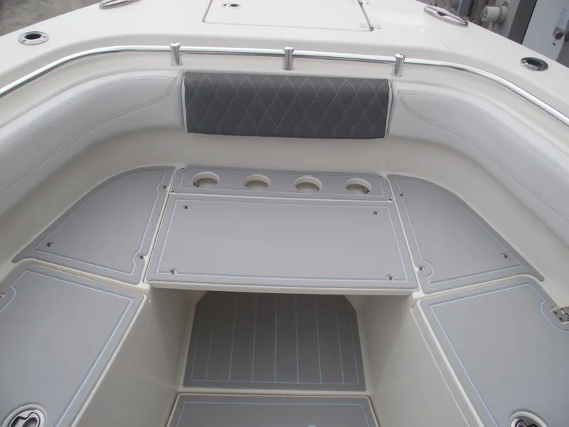 Slide: The Image of 2021 Cobia 301 Center Console boat interior with cushioned seating and storage compartments. - 13