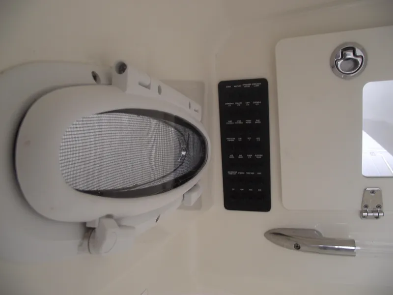 Slide: The Image of 2021 Cobia 301 Center Console interior detail with control panel and hatch. - 22
