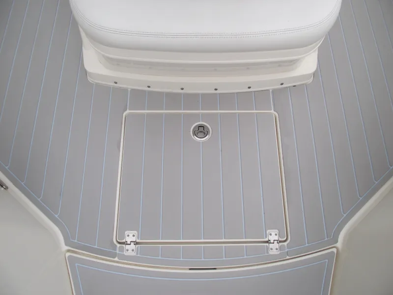 Slide: The Image of 2021 Cobia 301 Center Console boat deck with storage hatch and seating. - 23