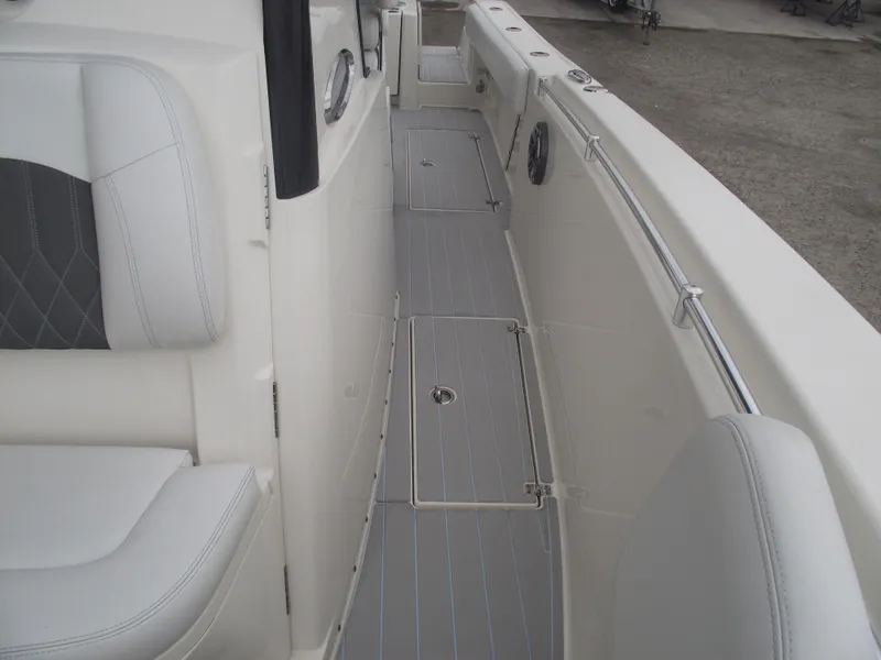 Slide: The Image of 2021 Cobia 301 Center Console boat interior with gray seating and deck. - 26
