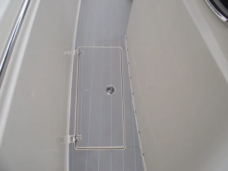 Slide: The Image of 2021 Cobia 301 Center Console boat deck with storage hatch. - 27