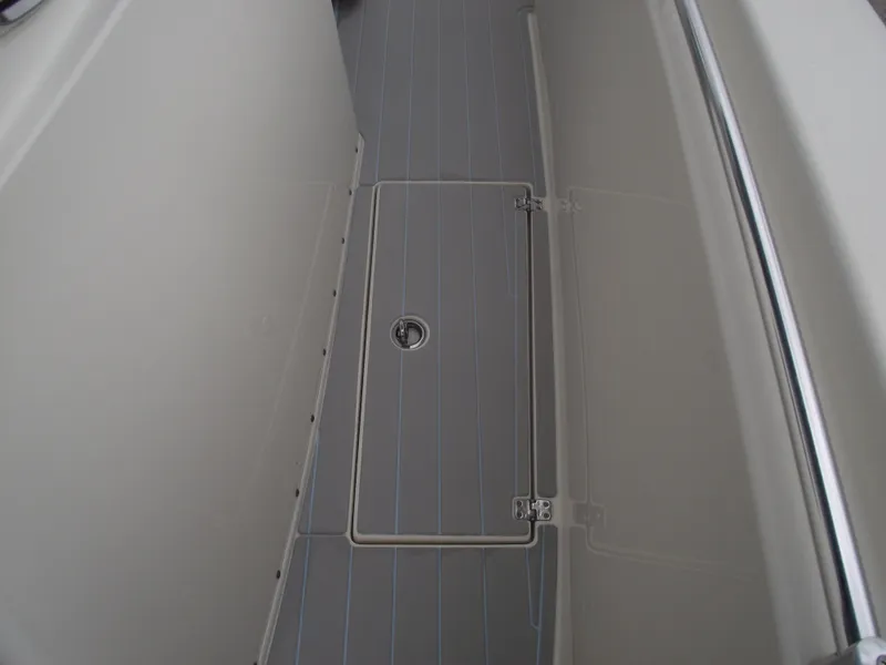 Slide: The Image of 2021 Cobia 301 Center Console boat deck with storage hatch and railing. - 29