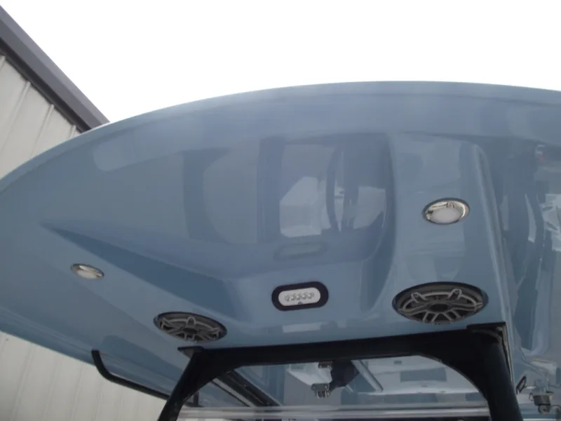Slide: The Image of 2021 Cobia 301 Center Console boat's blue T-top with speakers and lights. - 31