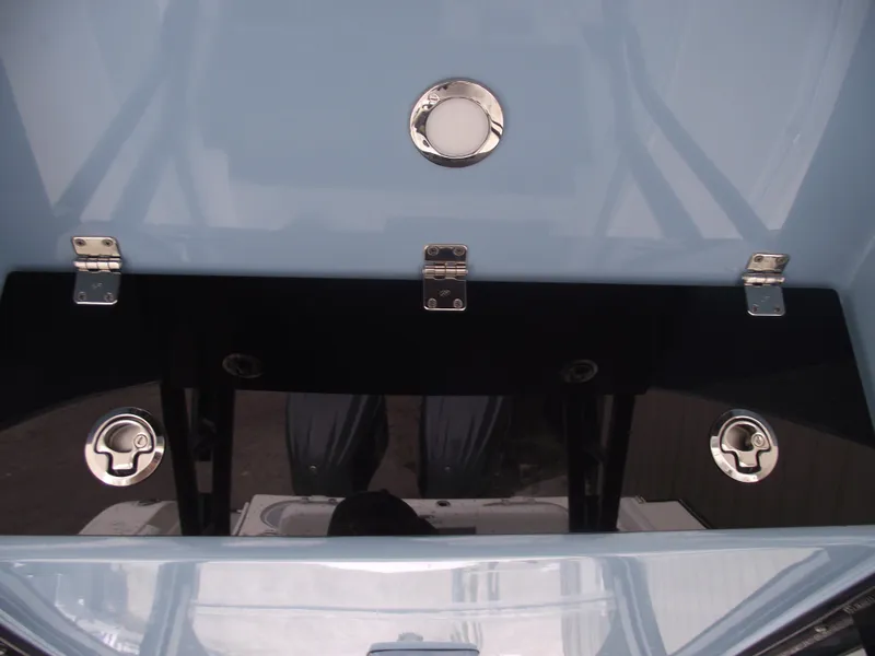 Slide: The Image of 2021 Cobia 301 Center Console boat deck with stainless steel fittings and storage compartments. - 37