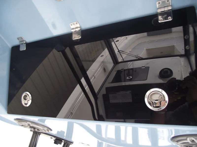 Slide: The Image of 2021 Cobia 301 Center Console boat interior with sleek black panel and metallic fixtures. - 39