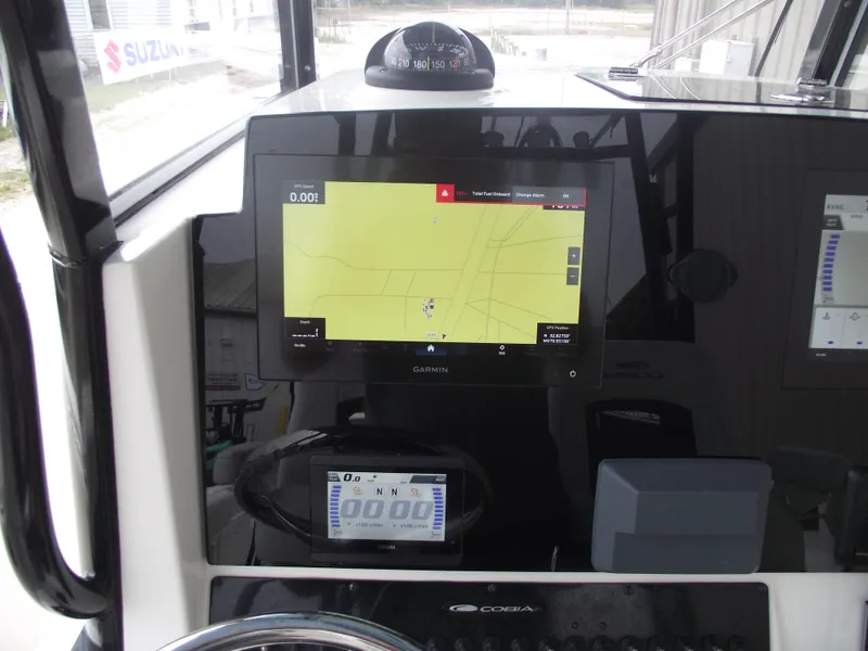 Slide: The Image of 2021 Cobia 301 Center Console dashboard with Garmin navigation display. - 42