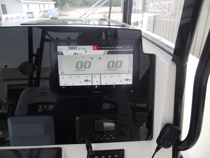 Slide: The Image of Cobia 301 Center Console 2021 dashboard with Garmin display and controls. - 43