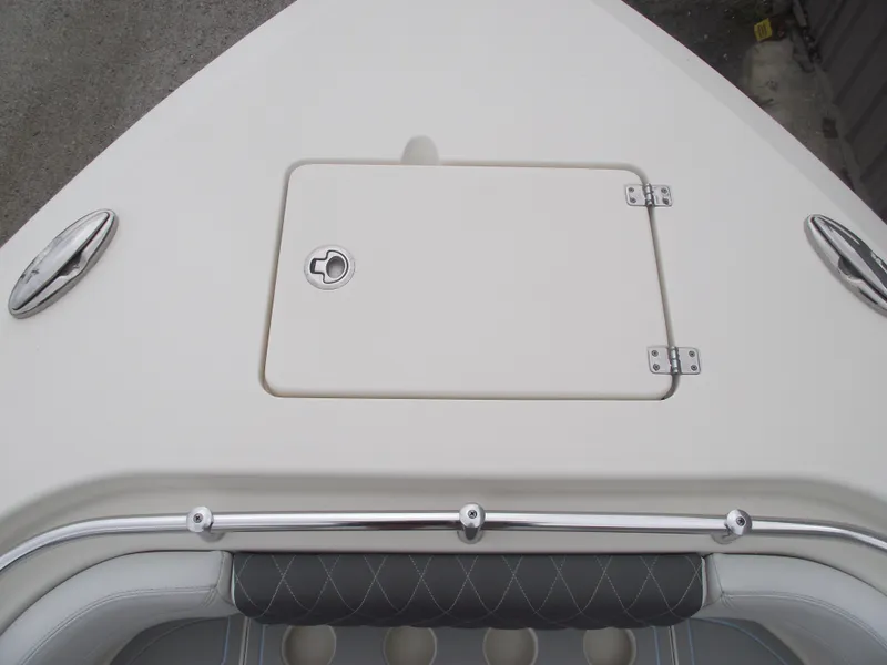 Slide: The Image of 2021 Cobia 301 Center Console boat deck with storage hatch and stainless steel fittings. - 7