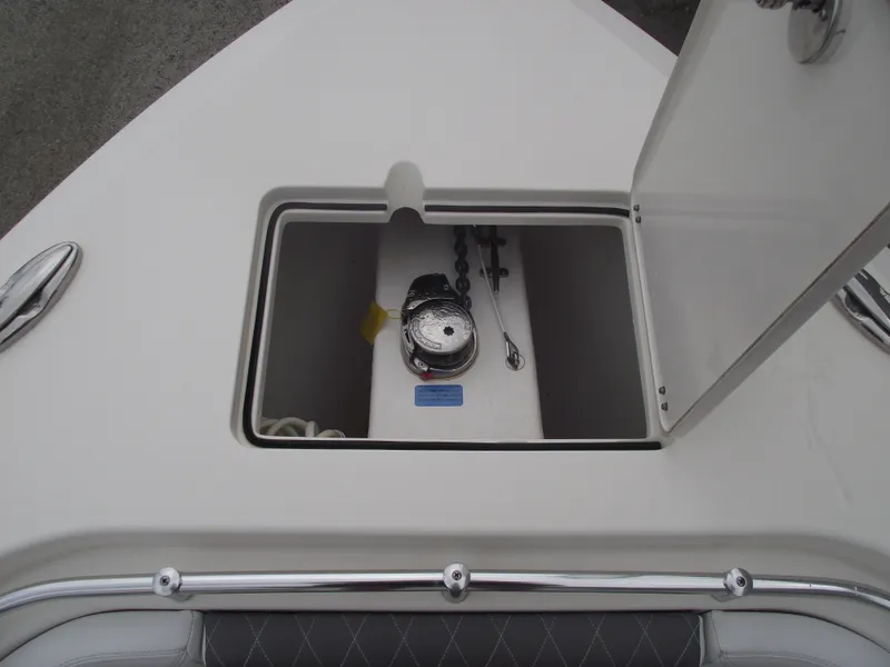 Slide: The Image of 2021 Cobia 301 Center Console anchor locker with open hatch and visible anchor chain. - 8