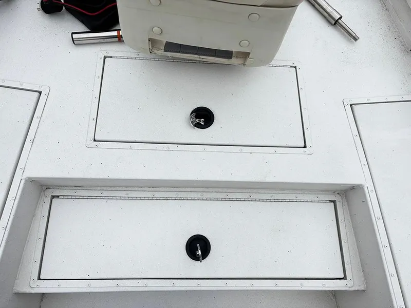 Slide: The Image of 2023 G3 Bay 18 GX boat deck with storage compartments and seating. - 13