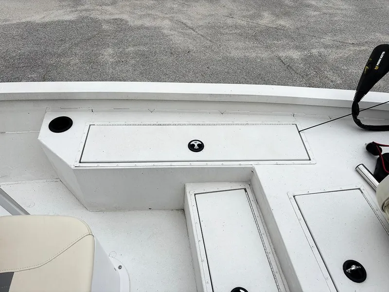 Slide: The Image of 2023 G3 Bay 18 GX boat deck with storage compartments and seating area. - 18