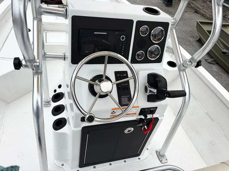 Slide: The Image of 2023 G3 Bay 18 GX boat console with steering wheel and gauges. - 22