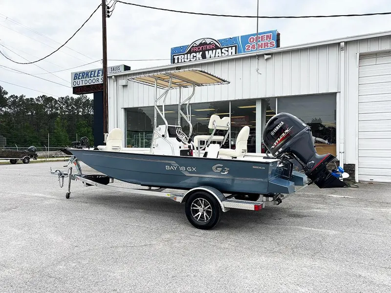Slide: The Image of 2023 G3 Bay 18 GX boat on trailer outside a truck wash facility. - 3