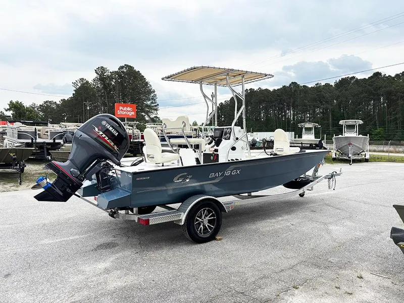 Slide: The Image of 2023 G3 Bay 18 GX boat with Yamaha outboard motor on trailer, parked outdoors. - 7