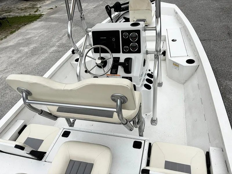 Slide: The Image of 2023 G3 Bay 18 GX boat interior with steering console and seating. - 9