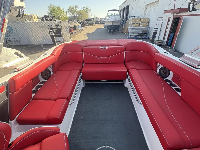 Slide: The Image of 2018 MasterCraft XT23 boat with vibrant red seating and spacious interior design. - 12