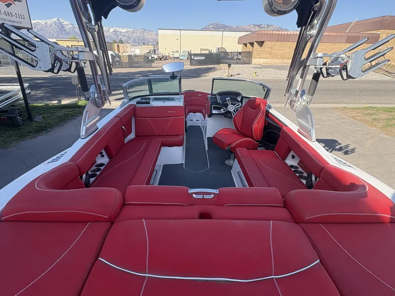 Slide: The Image of 2018 MasterCraft XT23 boat with red seating, spacious interior, and modern design. - 13