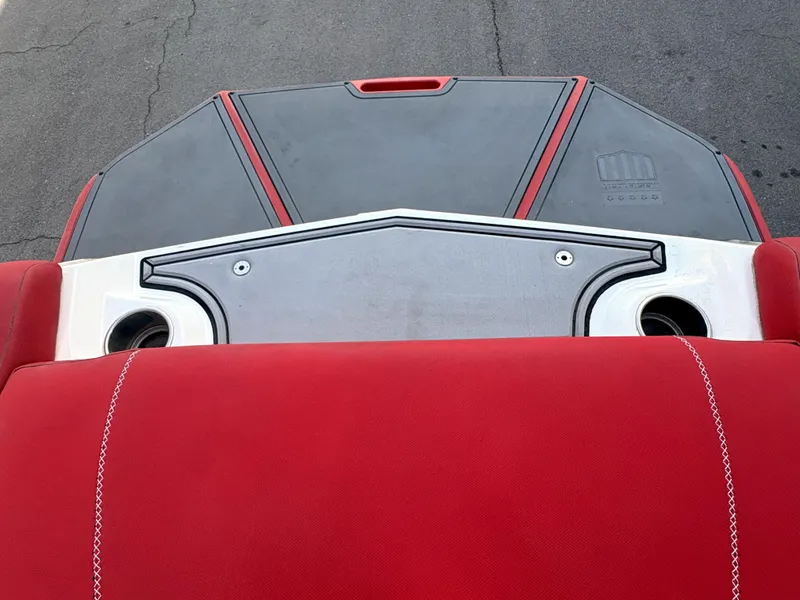 Slide: The Image of 2018 MasterCraft XT23 boat with red and black seating and deck design. - 14